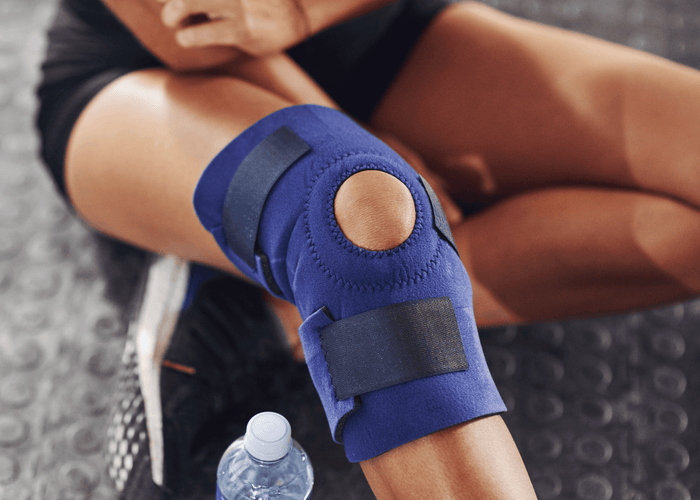 Blue knee brace for pain relief - Optimum Mind & Movement Collective